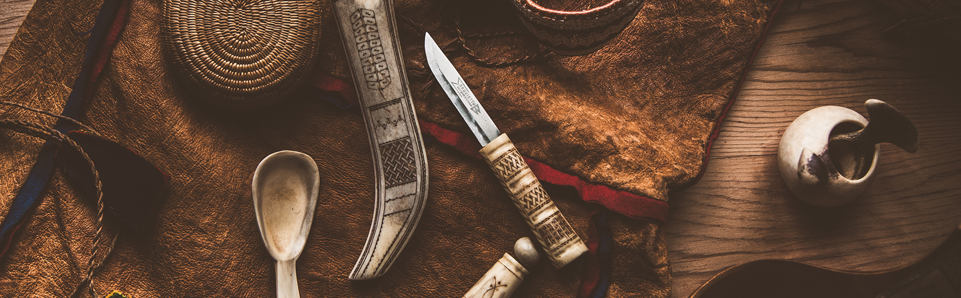 Samiska slöjdföremål ligger på ett skinn.